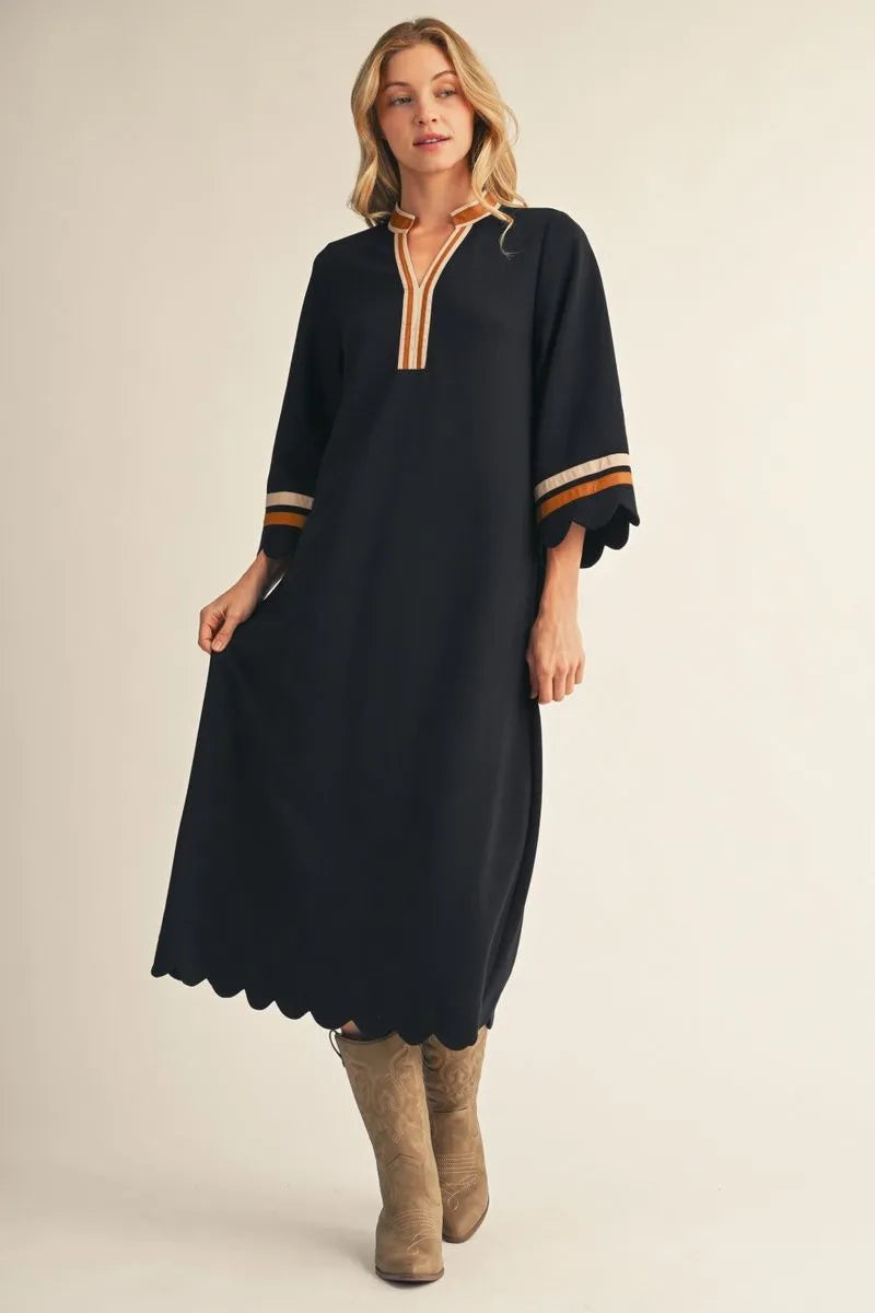 Black Solid Midi Dress With Scalloped Edges, featuring gold and white trim on the collar and cuffs, relaxed silhouette, scalloped hem and sleeves. Available in sizes XS–XL.
