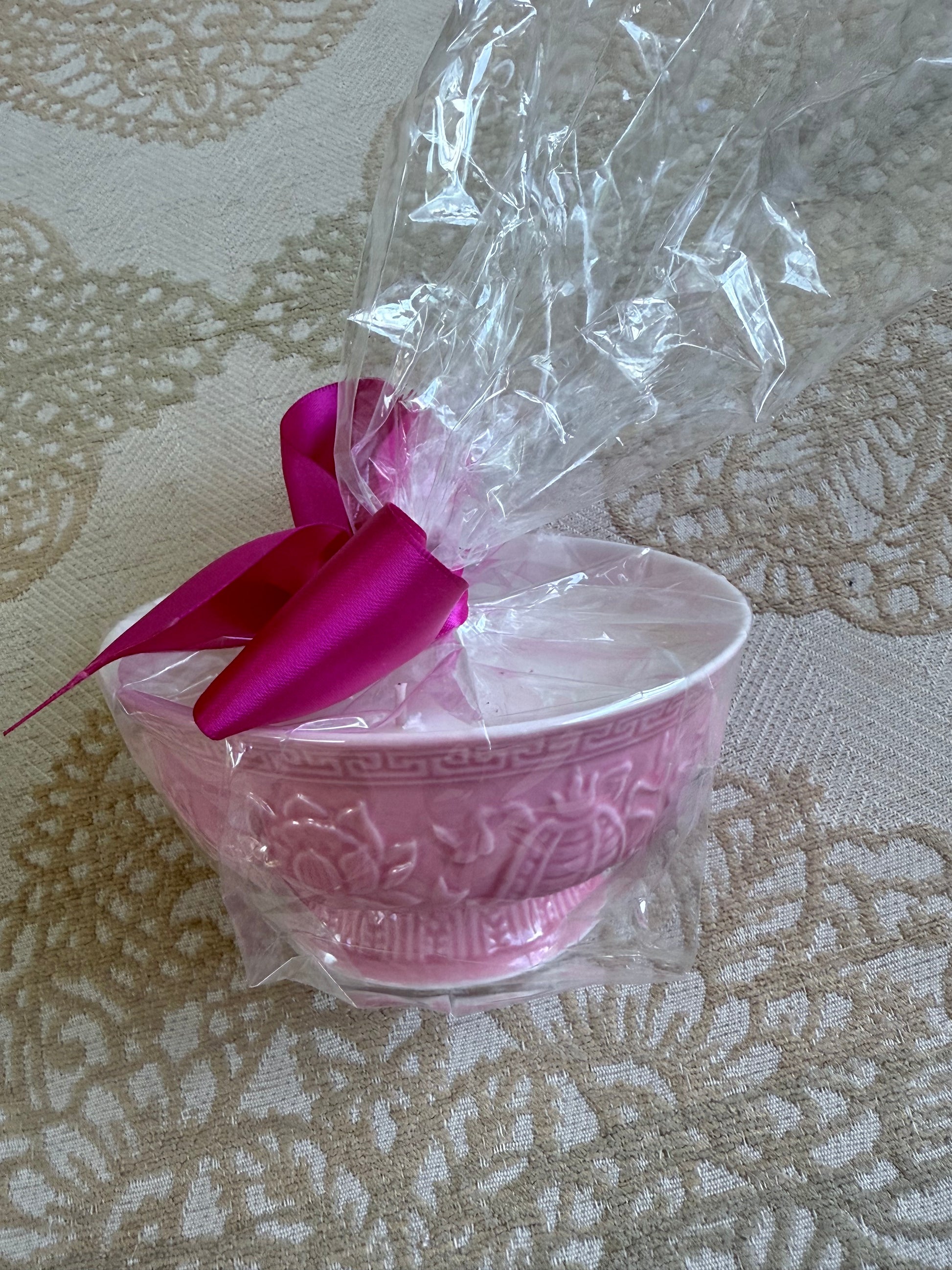 French Bee Candle in pink ceramic bowl, wrapped in clear plastic with pink ribbon; available in small, medium, and large sizes.
