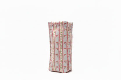 Rectangular, upright pouch with red bow and green dot stripes on white. Available sizes: small, medium, large.