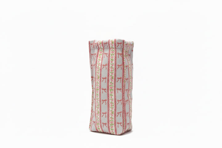 Rectangular, upright pouch with red bow and green dot stripes on white. Available sizes: small, medium, large.