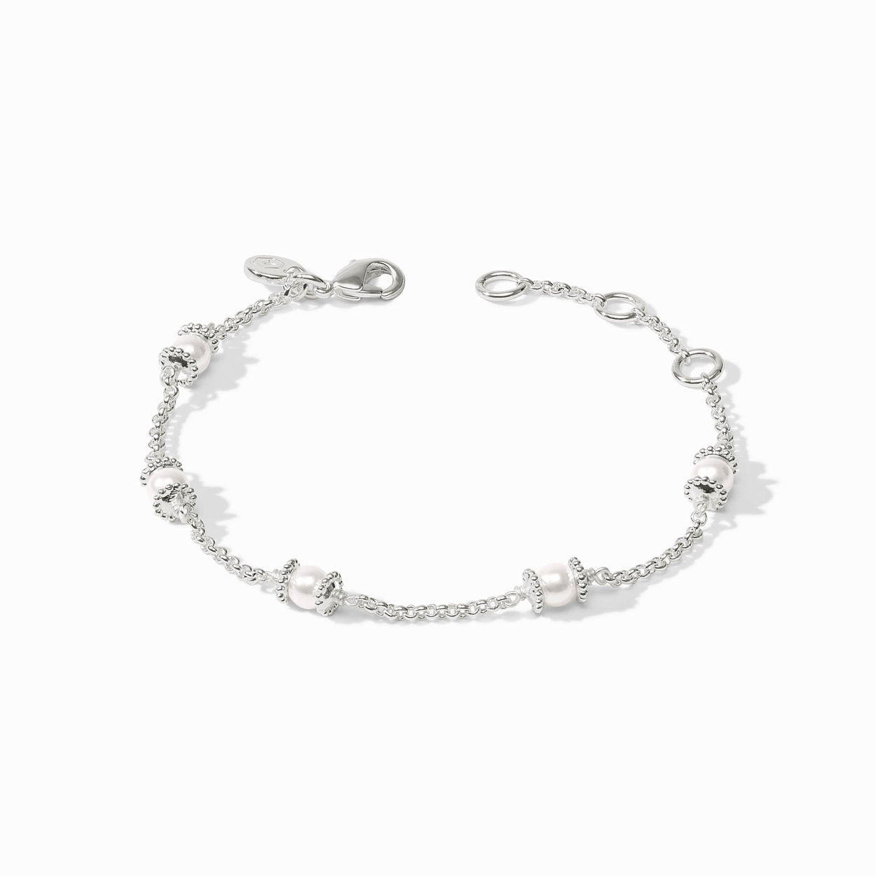 Silver chain bracelet with five small white beads framed by silver rings, lobster clasp. Available in multiple sizes.