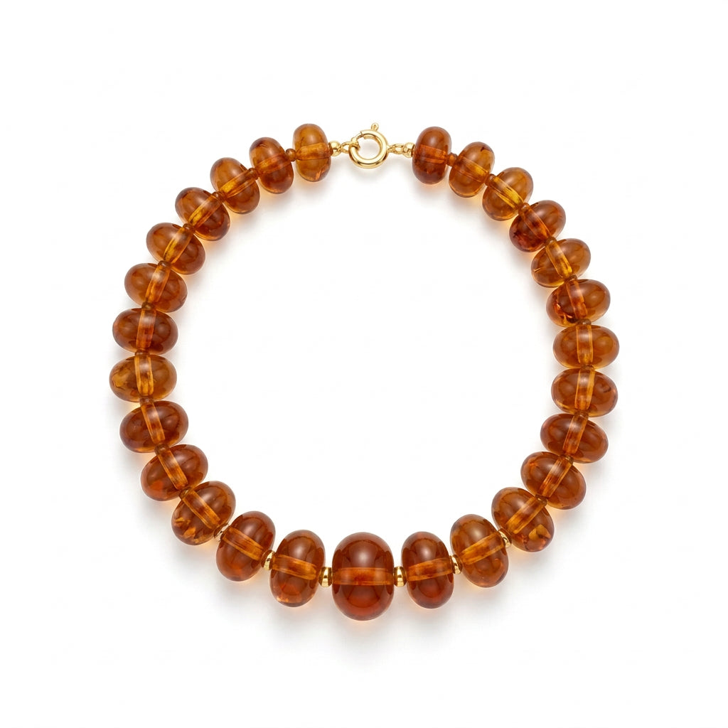 Oblong amber-colored beaded necklace with a silver clasp.