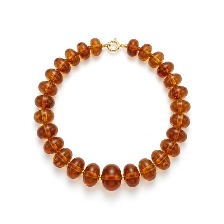 Oblong amber-colored beaded necklace with a silver clasp.