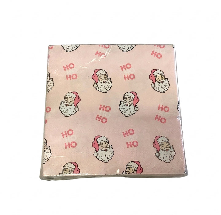 Light pink Merry &amp; Bright cocktail napkins with a Santa Claus and “HO HO” pattern.