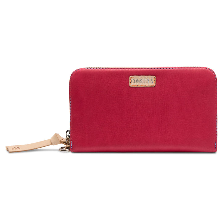 Red leather zip wallet with tan logo patch and wrist strap, debossed details; available in small and large sizes.