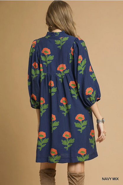 Kelly Navy Mix Dress: mini length, red and green floral print, puffy 3/4 sleeves, subtle V-neck. Sizes XS–XL.