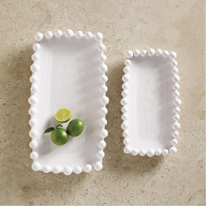 Two white Raised Dot Platters with round, raised edges. Available in multiple sizes.