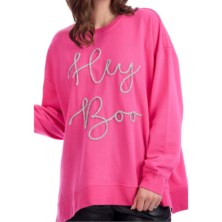 Oversized bright pink Hey Boo Tinsel Sweatshirt with “Hey Boo” in cursive on the front. Available in sizes S-XXL.