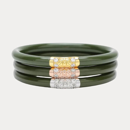 Set of three jade-hued bangle bracelets, each with a decorative clasp in gold, rose gold, or silver featuring an embossed emblem and clear stones. Available in small, medium, and large sizes.