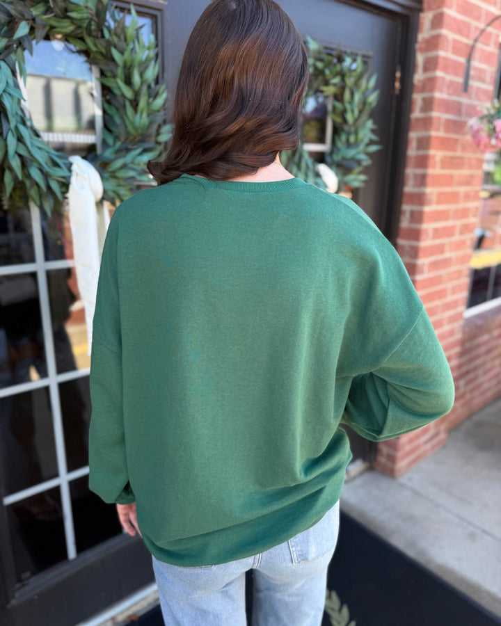 Dark green long-sleeve Alpine Nutcracker sequin crewneck sweatshirt.