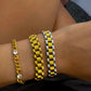 Three metallic bracelets in varying styles:

1. Thin gold chain with white accents.
2. Thick Gold Watchband Bracelet with block-like gold design.
3. Gold and silver bracelet with a luxurious design.

Sizes available: S, M, L.