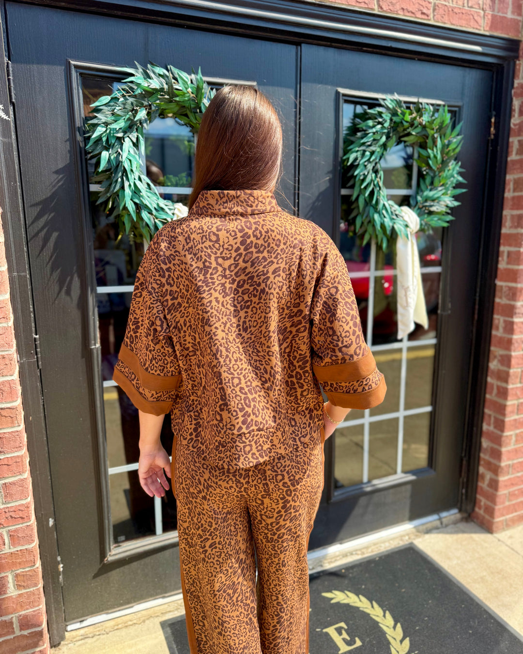 Leopard Zip-Up Top with zip closure and leopard print, available in sizes XS-XL.