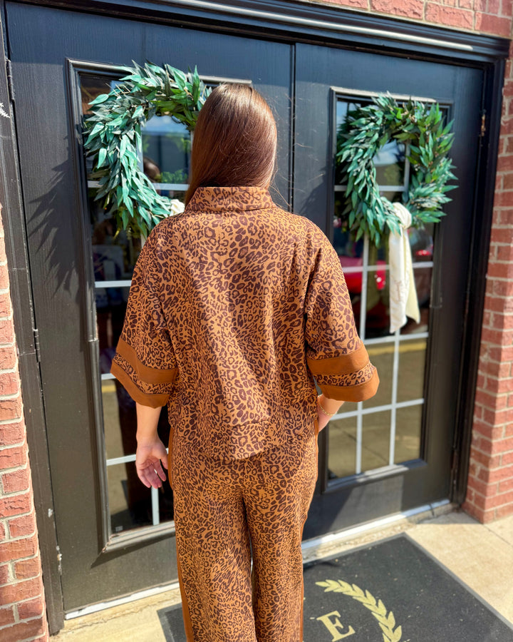 Leopard Zip-Up Top with zip closure and leopard print, available in sizes XS-XL.