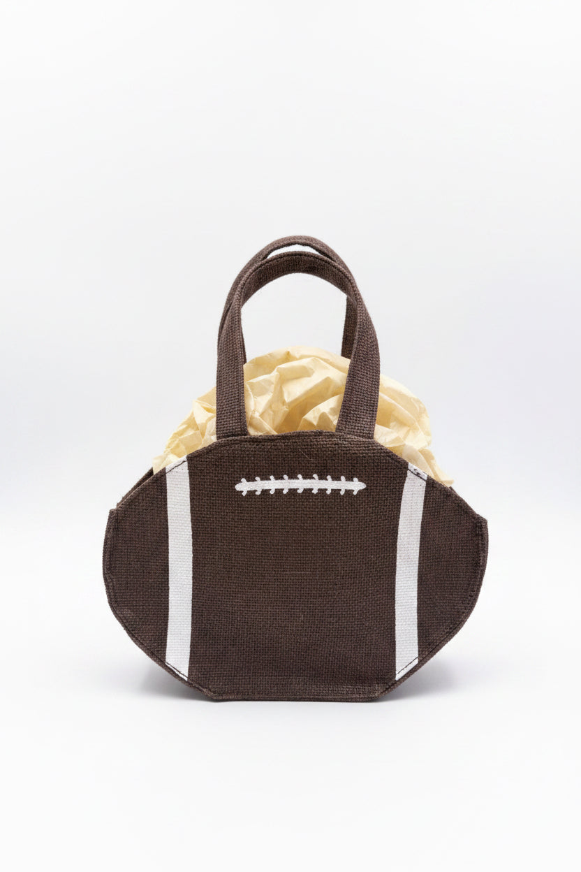 Football Petite Gift Tote shaped like an American football with brown coloring, white stitching, and stripes; includes tan tissue paper. Available in petite size.