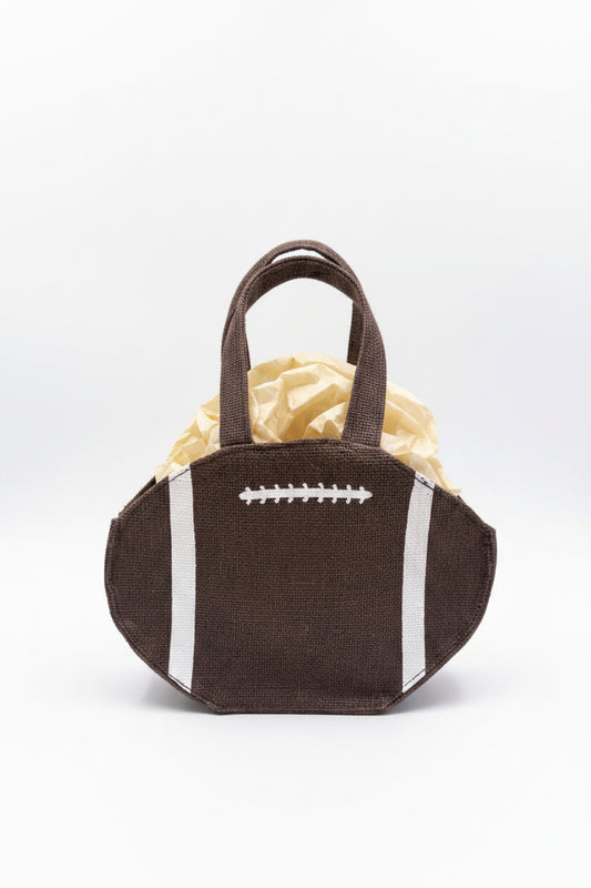Football Petite Gift Tote shaped like an American football with brown coloring, white stitching, and stripes; includes tan tissue paper. Available in petite size.