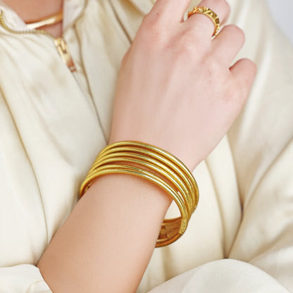 Aura Lumine All Weather Bangles shown stacked, size Large; also available in other sizes.