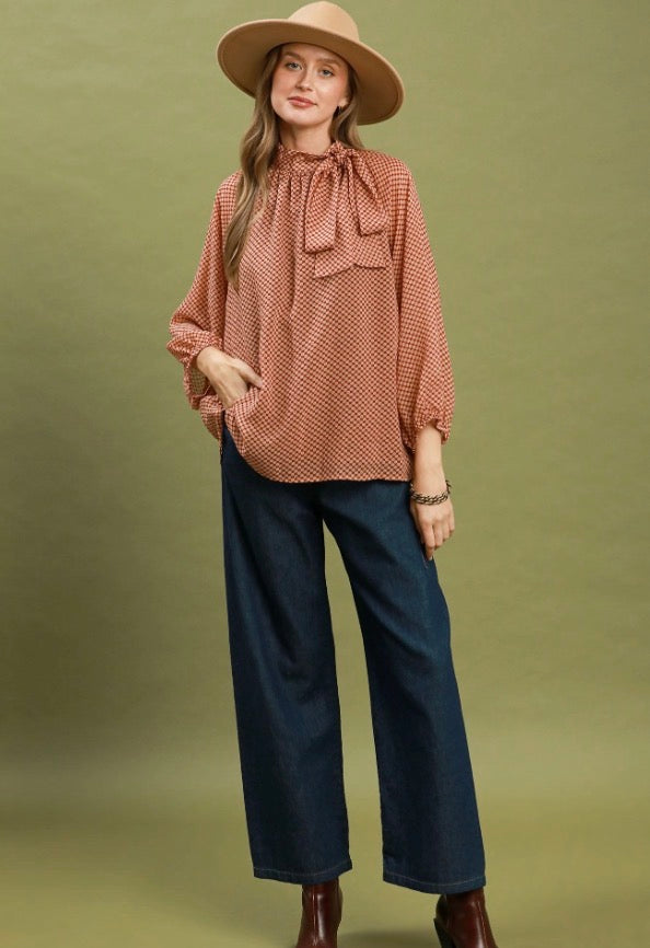 The Dottie Tie Top features statement balloon sleeves and is available in sizes XS–XL.
