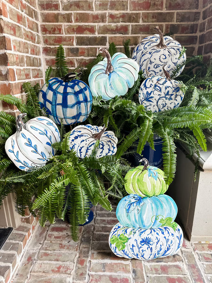 Beck’s Blue &amp; White Pumpkins: a decorative metal pumpkin set featuring assorted blue, white, and green patterns, including one three-tier stack.