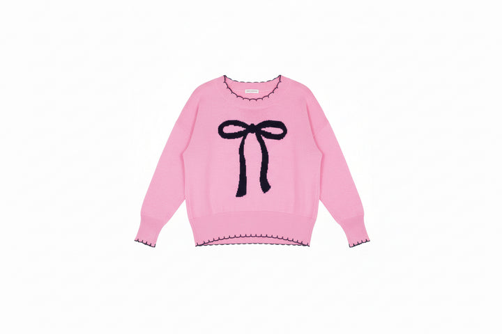 Light pink long sleeve sweater with black bow and scalloped trim; available in sizes XS-XL.