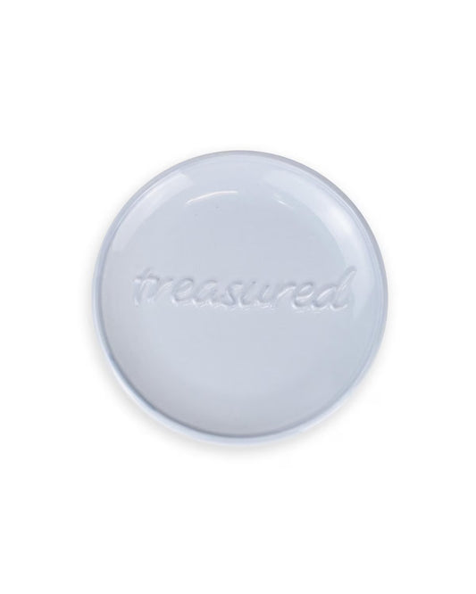 Small, round ceramic dish with "treasured" in cursive; 4” size, ideal for storing small items.
