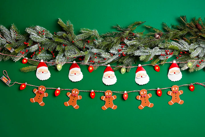 Light-Up Christmas Garlands: two strands of battery-operated string lights with smiling Santa and gingerbread men ornaments.