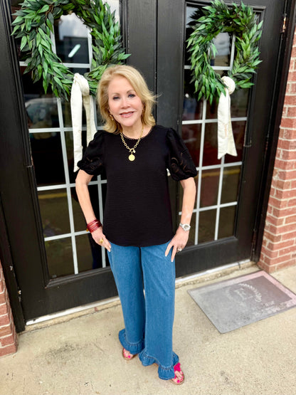 Haley Black Top with embroidered eyelet sleeves; available in sizes XS-XL.