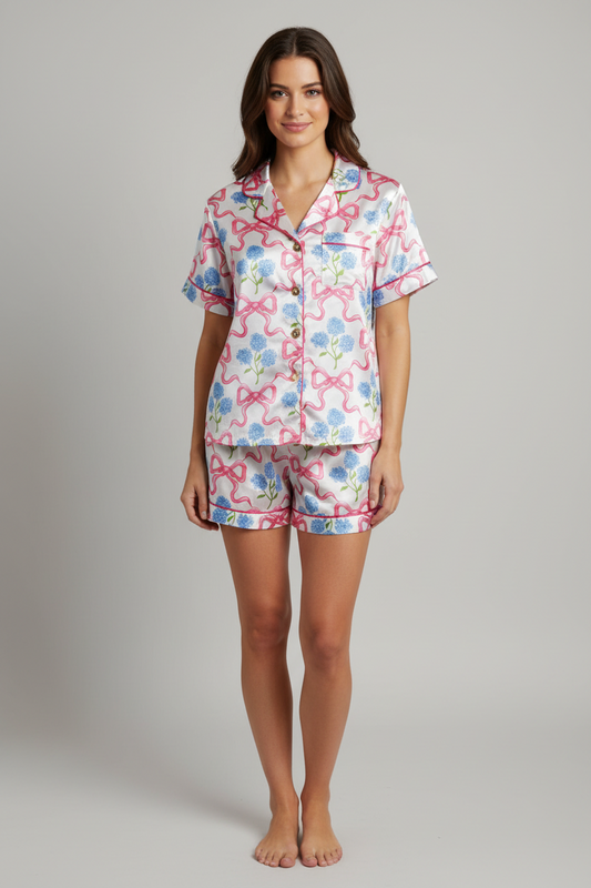 Woman wearing a floral pajama set on a gray background
