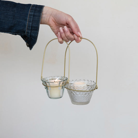 Antique brass wire handle with two Hanging Pressed Glass Votive Holders, each holding a lit candle. Sizes: Small, Large.