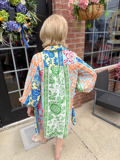 On Vacation Time Dress with blue, green, orange, and pink botanical stripes. Available in XS–XL.