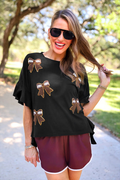 Sideline Sparkle Ruffle Top with gold and brown football bow patches. Available in sizes XS-XL.