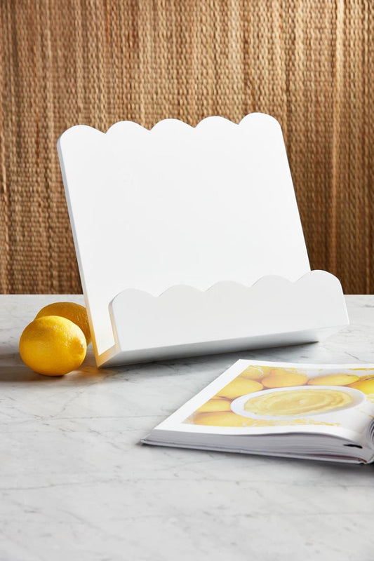 White scalloped-edge Scallop Cookbook Holder. Sizes available: small, medium, large. Holds an open cookbook upright.