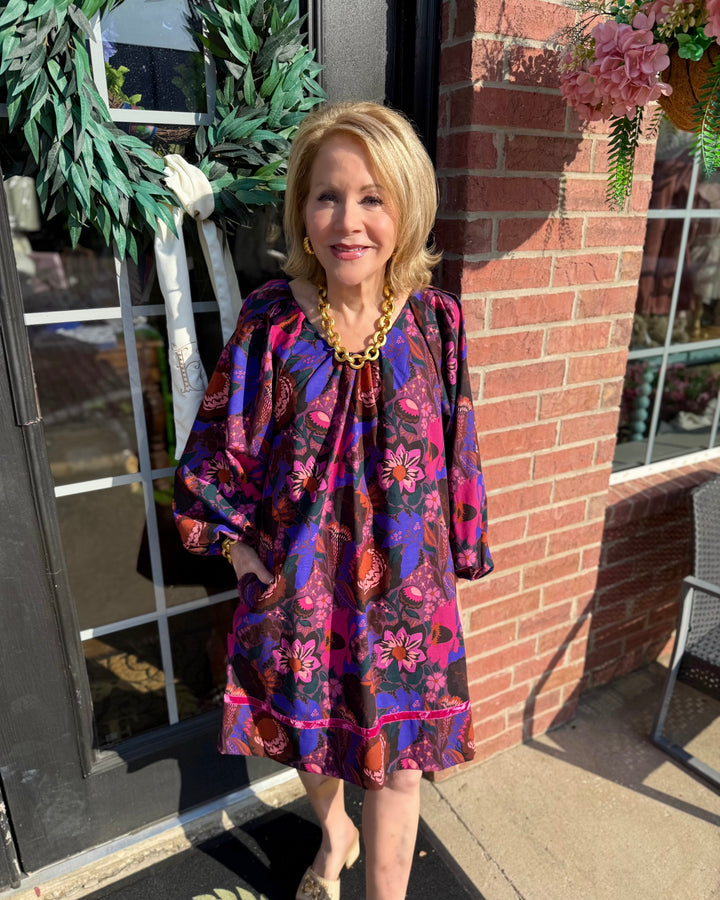Shirred Floral Shift Dress in a vibrant fall print, features shirred detailing and pockets. Available in sizes XS-XL.