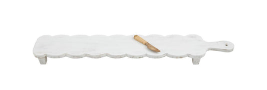 Long, white mango wood cheese board with scalloped edges, short legs. Includes small wooden spreader. Size: Long.