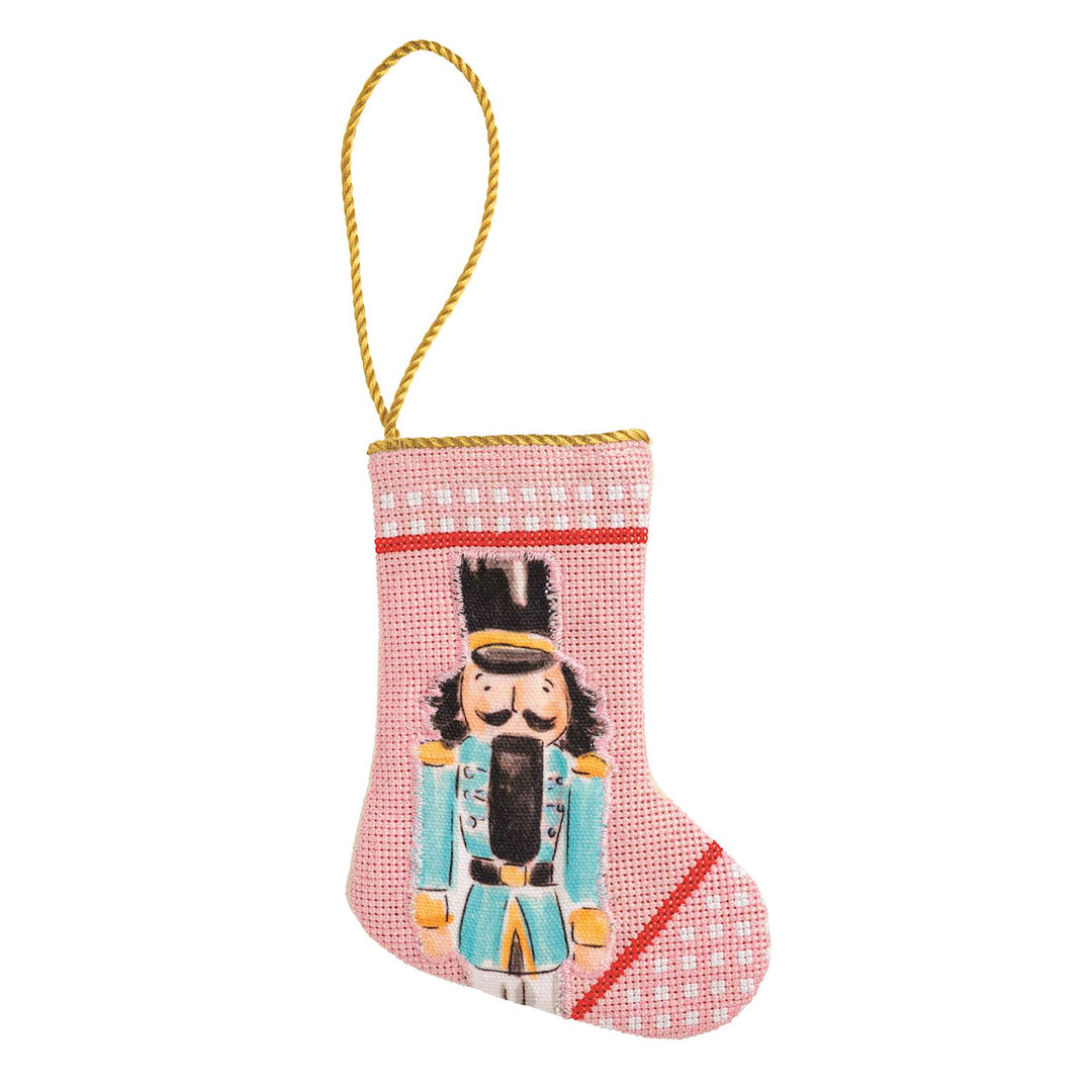 Needlepoint Nutcracker Mini Stocking, pink with nutcracker motif and gold hanging cord.