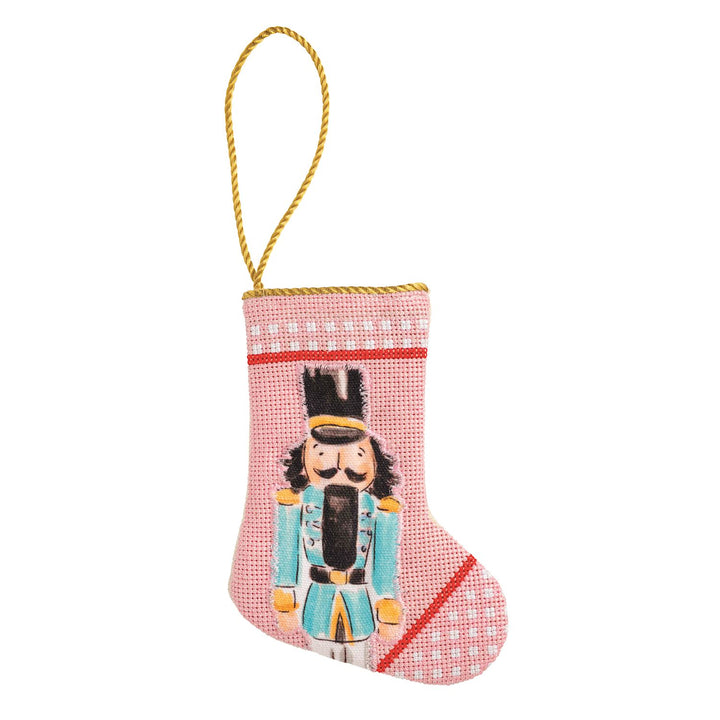 Needlepoint Nutcracker Mini Stocking, pink with nutcracker motif and gold hanging cord.