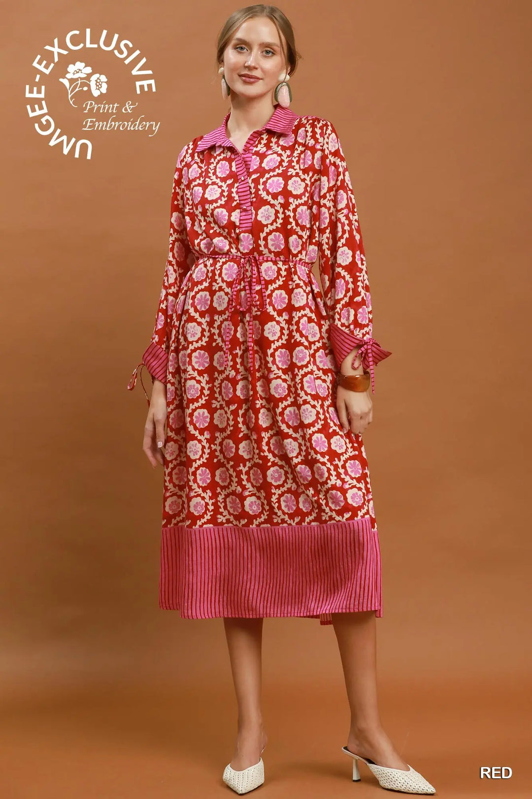 Red and pink mixed media print midi dress featuring a collared neckline, button-down front, long sleeves with tie cuffs, and a striped hem. Available in multiple sizes.