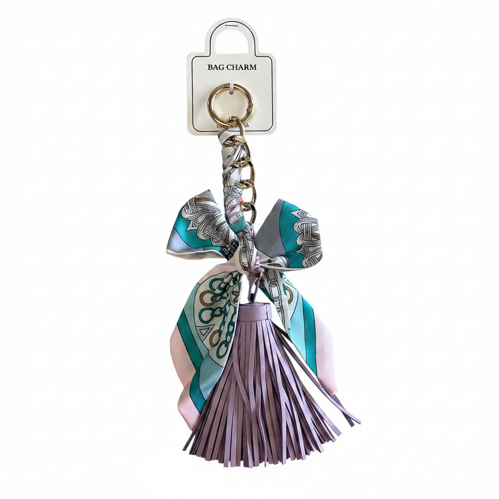 Gold keyring with a teal, pink, and white patterned scarf and large lilac tassel. Sizes available: not specified.