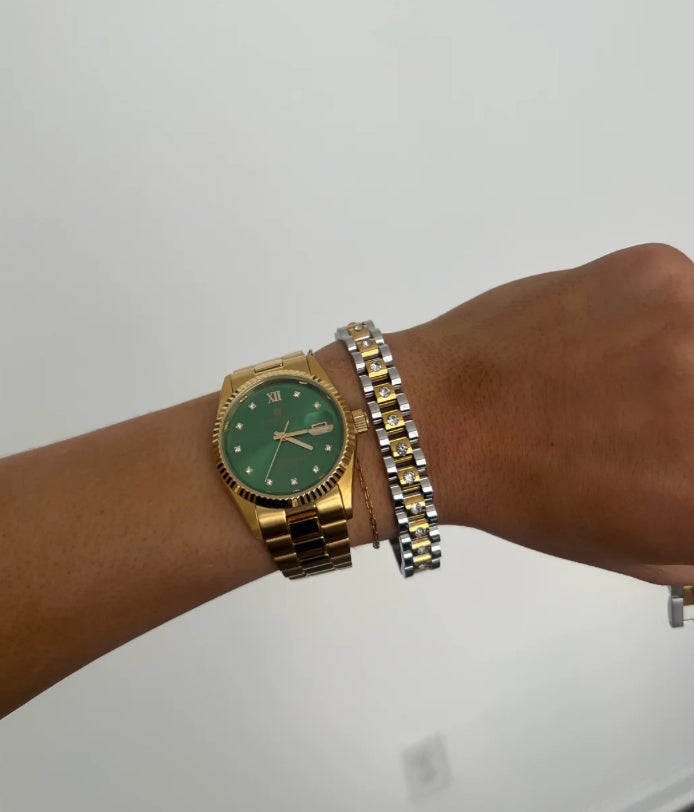 Gold watch with a green face, Roman numerals, and date window. Sizes: One size fits most. Diamond Two Toned Watch Band Bracelet included.