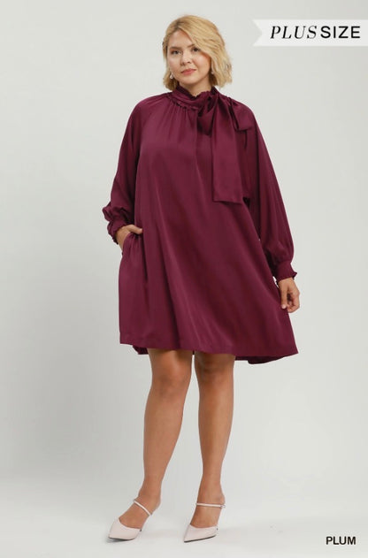 Satin Tie Neck Dress: loose, long-sleeve, plum satin dress with high neckline and bow detail. Available in plus sizes.