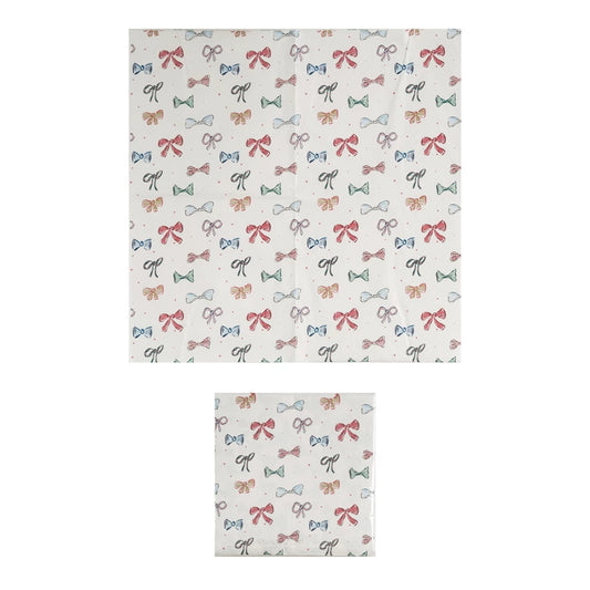 Square 6-1/2” paper napkins with red, green, and black bow pattern; available in 6-1/2” size.