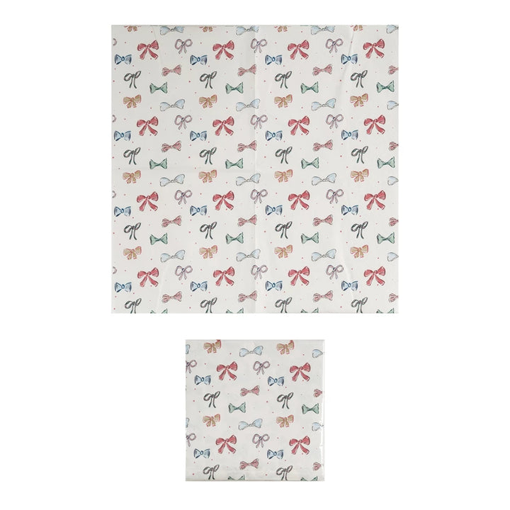 Square 6-1/2” paper napkins with red, green, and black bow pattern; available in 6-1/2” size.