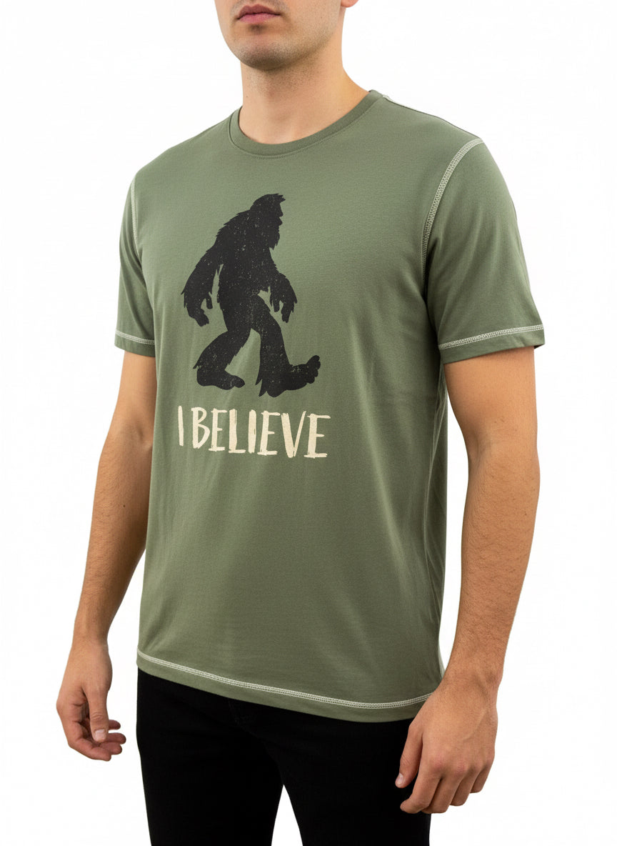 Olive green Men’s I Believe T-Shirt with white stitching, black Bigfoot above "I BELIEVE." Available in S-XXL.
