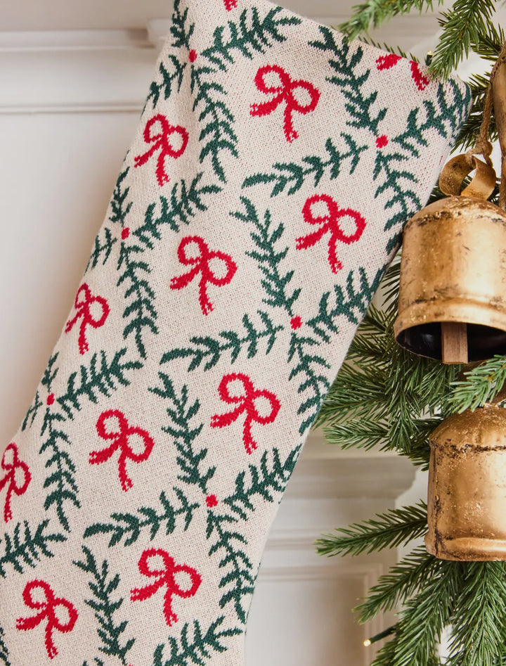 Holiday Trellis Stocking featuring a knit design with a repeating trellis pattern of red bows and green pine branches.