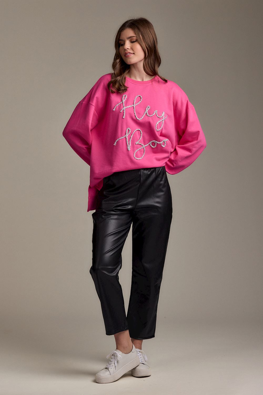 Hey Boo Tinsel Sweatshirt in bright pink; available in sizes XS–XL.