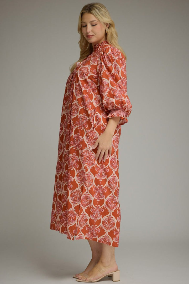 Nora Ruffle Midi Dress in rust with cream botanical print, high ruffle collar, loose bodice, and balloon sleeves. Available in all sizes.