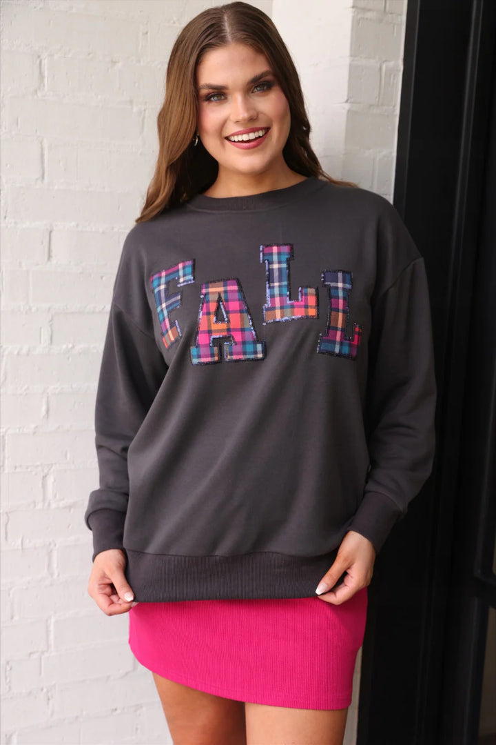 Fall Plaid Patch Pullover: cozy autumn sweater with colorful plaid letters spelling “FALL.” Available in sizes S-XL.
