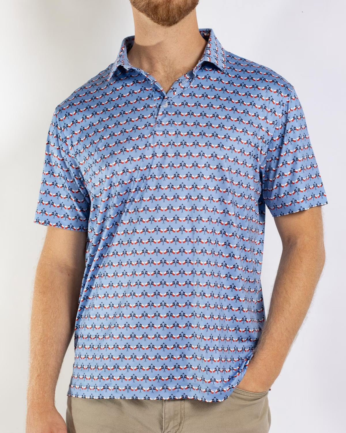 Men’s Texas Flag Performance Polo with a blue patterned design and small repeating motifs. Available in sizes S-XXL.