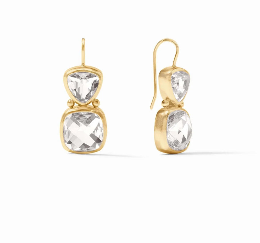 The Aquitaine Earring Gold Clear Crystal dangle earrings are elegant in design, featuring two faceted trillion cut gemstones per earring, meticulously bezel-set. The gems exhibit clarity and lustre. They come in one standard size suitable for all.