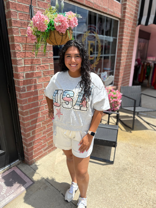 USA Patch Tee in light gray, 100% cotton. Available sizes: XS–XL.
