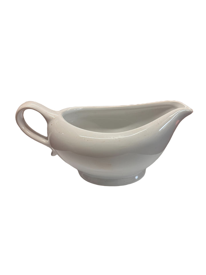 Plain white stoneware gravy boat with handle and spout; available in 12 oz and 16 oz sizes.